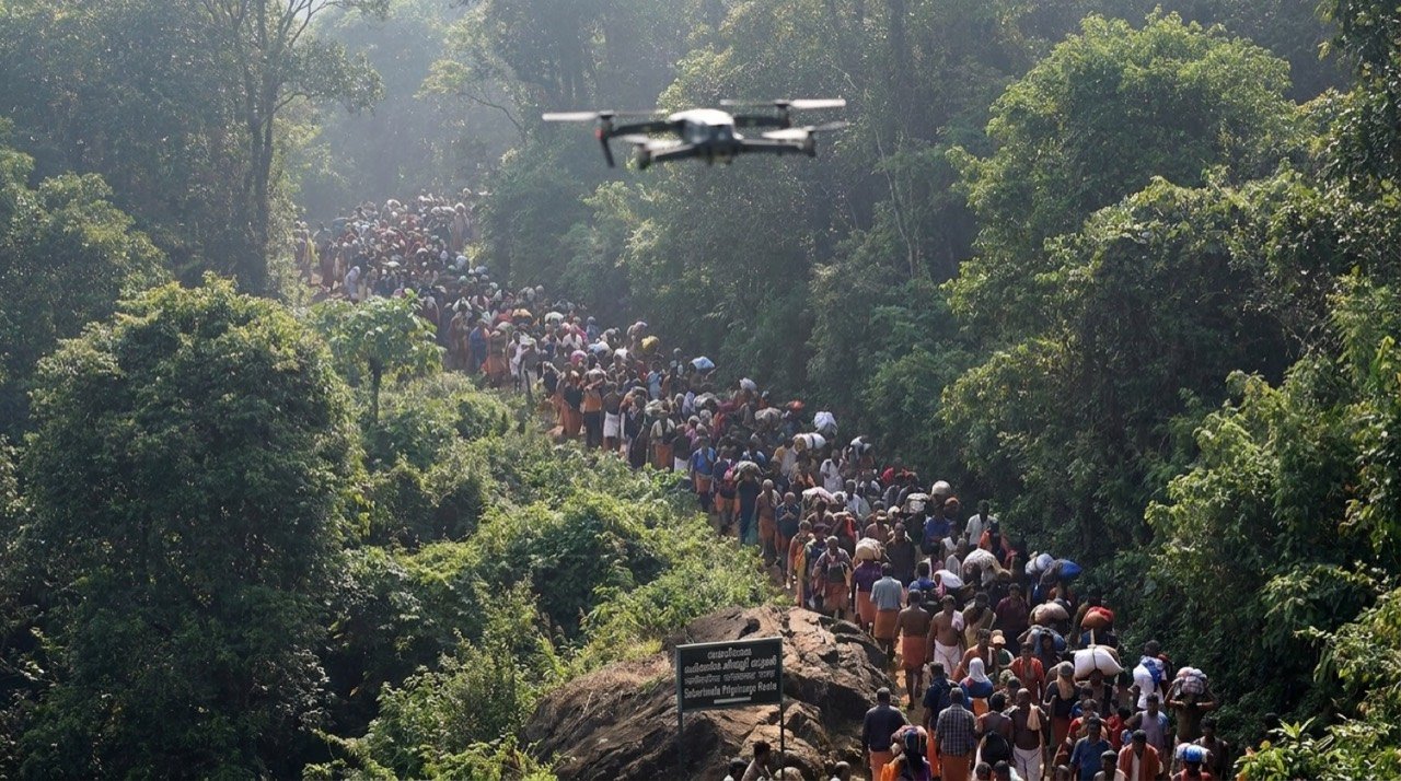 Drone monitoring pilgrim crowds on the forested hill route to Sabarimala temple in Kerala